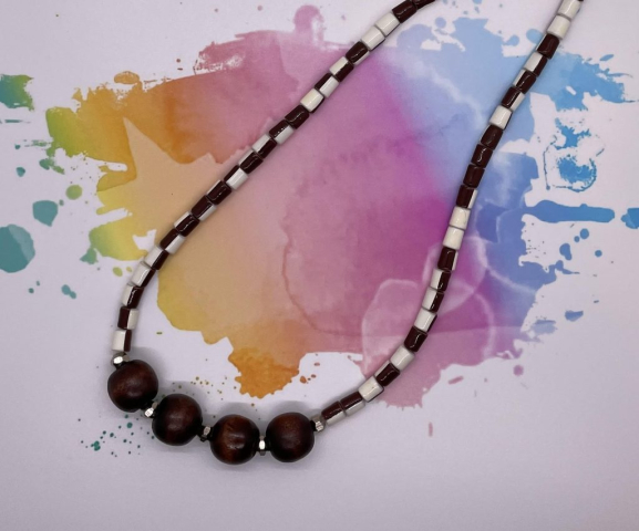 Unisex Choker- Vintage Coated Acrylic White and Brown Tube Beads. Silver Metal Faceted Accent Beads. Large Polished Wood Beads. Approx. length: 19 1/4 inches. Pronounced: AT-toh Origin: Igbo Meaning: The Land is Praised