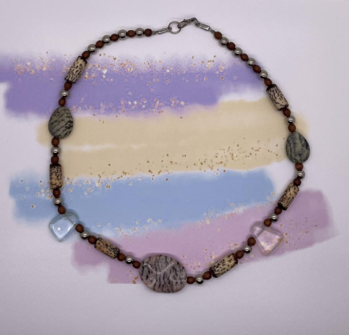 Unisex Choker- Silver Metal Balls. Brown Wood Balls. Betel Nut Tube Beads. Green Tiger Striped Gemstones. Clear Acrylic Beads. Opaque Tiger Striped Gemstone Centerpiece. Approx. length: 19 inches. Pronounced: DAH-lit-so Origin: Chewa Meaning: Blessing