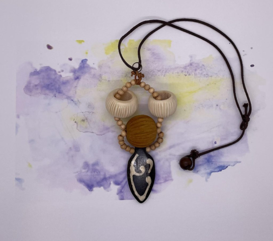 Unisex Choker- Wood Bead Accents. Hollow Bone Etched Beads. Wood Etched Center Ball. Bone Shield Pendant. Cotton Rope Strung. Wood Ball Loop Closure. Approx. length: 19 inches. Pronounced: ZOO-beh-ree Origin: Eastern Africa Meaning: Strong