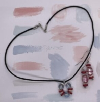 Choker Set- Translucent Round Glass Beads. Red and White Rondelle Beads. White Acrylic Discs. Approx. length: 17 inches. Black, Nylon Strung. Earrings to Match. Red and White Rondelle Beads. White Acrylic Discs. Translucent Oval Red Candy Striped Beads. Approx. length: 2 inches. .925 Sterling Silver Earwire. Pronounced: Eh-BEH-leh Origin: Igbo Meaning: Kindness