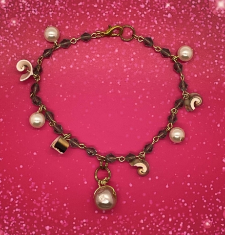 Ankle Bracelet- Transparent Blue Czech Crystal Bicon Beads. Natural Everlasting Shell Beads. Faux Pearls. Textured Faux Pearl Pendant. Approx. length: 9 1/4 inches. Pronounced: ah-DEH-bee-yee Origin: Yoruba Meaning: Royal One