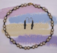 Choker Set- Antique White Faux Pearls. Faceted Hematite Accents. Approx. length: 18 inches. Earrings to Match 1 5/8 inches. Small and Large Hematite Barrel Beads. 14K Gold Filled Earwire. Pronounced: i-YAH Origin: Swahili Meaning: Bright