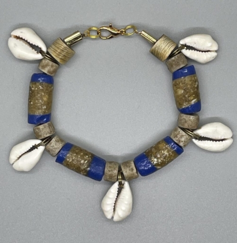 Wrist Bracelet- West African Artisan Hand Painted Tube Beads. Natural Stone Beads. Natural Cowrie Shells. Approx. length: 7 1/2 inches. Pronounced: EE-SA. Origin: Africa. Meaning: Gift