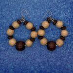 Earrings- Puffed Rondelle Beads. Antique White Wood Beads. Polished Brown Wood Beads. Approx. length: 2 1/2 inches. .925 Sterling Silver Earwire. Pronounced: EH-sheh Origin: Eastern African Meaning: One who is Alive