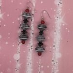 Earrings- Vintage Acrylic Red Beads. Old World Saucer Acrylic Beads. Vintage Acrylic Black Beads. Coconut Wood Disc Beads. Approx. length: 2 1/2 inches. .925 Sterling Silver Earwire. Pronounced: zhee-ZHEE-mah Origin: Zulu Meaning: Swift Runner