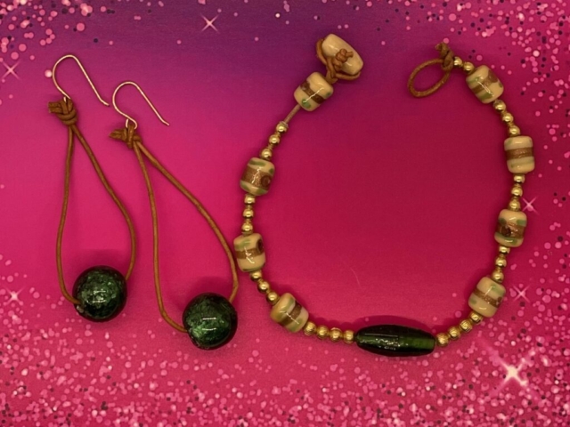 Ankle Bracelet- Smooth Gold Metal Balls. Strip Kente Krobo Beads. Engraved Gold Metal Balls. Leather Strung. Wood Ball Loop Closure. Approx. length: 9 inches. Earrings to Match. Large Green Glass Balls. Leather Strung. Approx. length: 3 inches. 14K Gold Filled Earwire. Pronounced: ee-FEN-ke-lee Origin: Ibo Meaning: Show Thing - Love