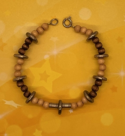 Wrist Bracelet- Natural Beige Wood Beads. Polished Brown Wood Beads. Silver Metal Rondelle Beads. Silver Metal Tube Beads. Approx. length: 7 inches. Pronounced: JAH-mee-lah Origin: Somali Meaning: Chaste