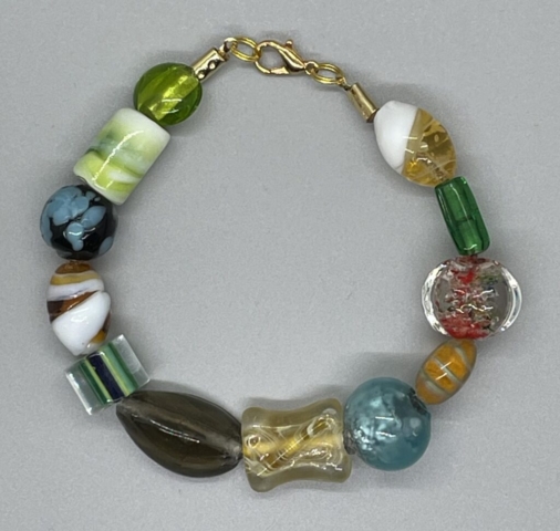 Wrist Bracelet- Multiple Glass Beads of various shapes and sizes. Opaque and Transparent. Approx. length: 8 1/2 inches. Pronounced: JO-HAH-REE. Origin: Africa. Meaning: Jewel