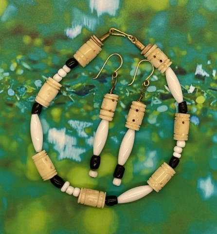 Ankle Bracelet- Ocean Shell Bead Accents. Carved Bone Barrel Beads. White Pony Beads. Black Glass Barrel Beads. White Acrylic Tube Beads. Approx. length: 10 inches. Earrings to Match. Approx. length: 3 inches. 14K Gold Filled Earwire. Pronounced: teh-teh-LAY-yo Origin: Yoruba Meaning: Joy Is Here To Stay