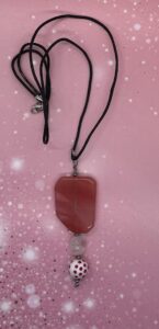 Necklace- Large Acrylic Salmon Color Bead. Oval Acrylic Bead. Round Polka Dot Acrylic Bead. Silver Metal Bead Accents. Approx. length: 27 inches. Pronounced: AH-deh-bin-peh. Origin: Yoruba. Meaning: Complete Child of the Crown