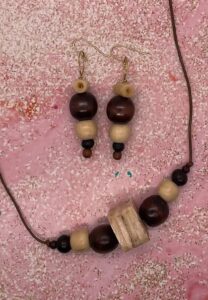 Necklace Set- Wood Balls Four Colors and Four Sizes. Layered Square Bone Bead Centerpiece. Leather Strung. Approx. length: 21 inches. 3 inch Earrings to Match. Carved Barrel Bone Beads. 4K Gold Filled Earwire. Pronounced: too-lew-TOE-PAY Origin: Yoruba. Meaning: God is Worthy of Thanks