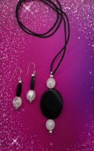 Necklace Set- Vintage White Opaque Acrylic Beads. Black Onyx Stone Centerpiece. Silver Metal Accent Balls. Nylon Strung. Approx. length: 24 inches. 2 inch Earrings to Match. Four Sided Acrylic Tube Beads. Vintage White Opaque Acrylic Beads. Silver Metal Accent Balls. Silver Metal Accent Beads. .925 Sterling Silver Earwire. Pronounced: ZUU-nah. Origin: African Meaning: Abundance